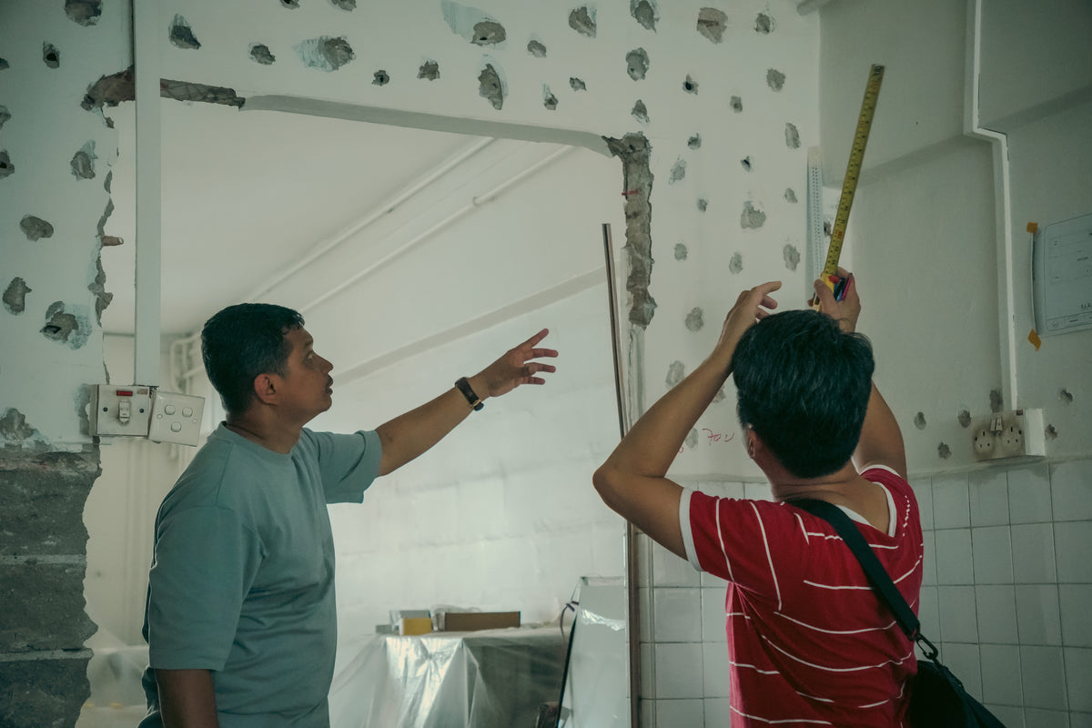 RCS team discussing and measuring a hacked wall on site