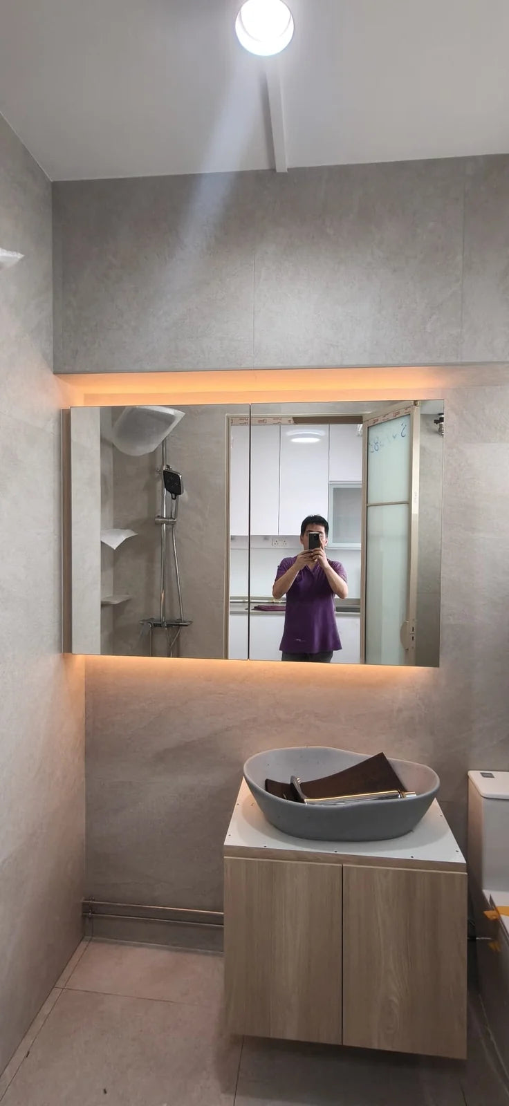 Completed bathroom vanity with mirror cabinet and cove lighting