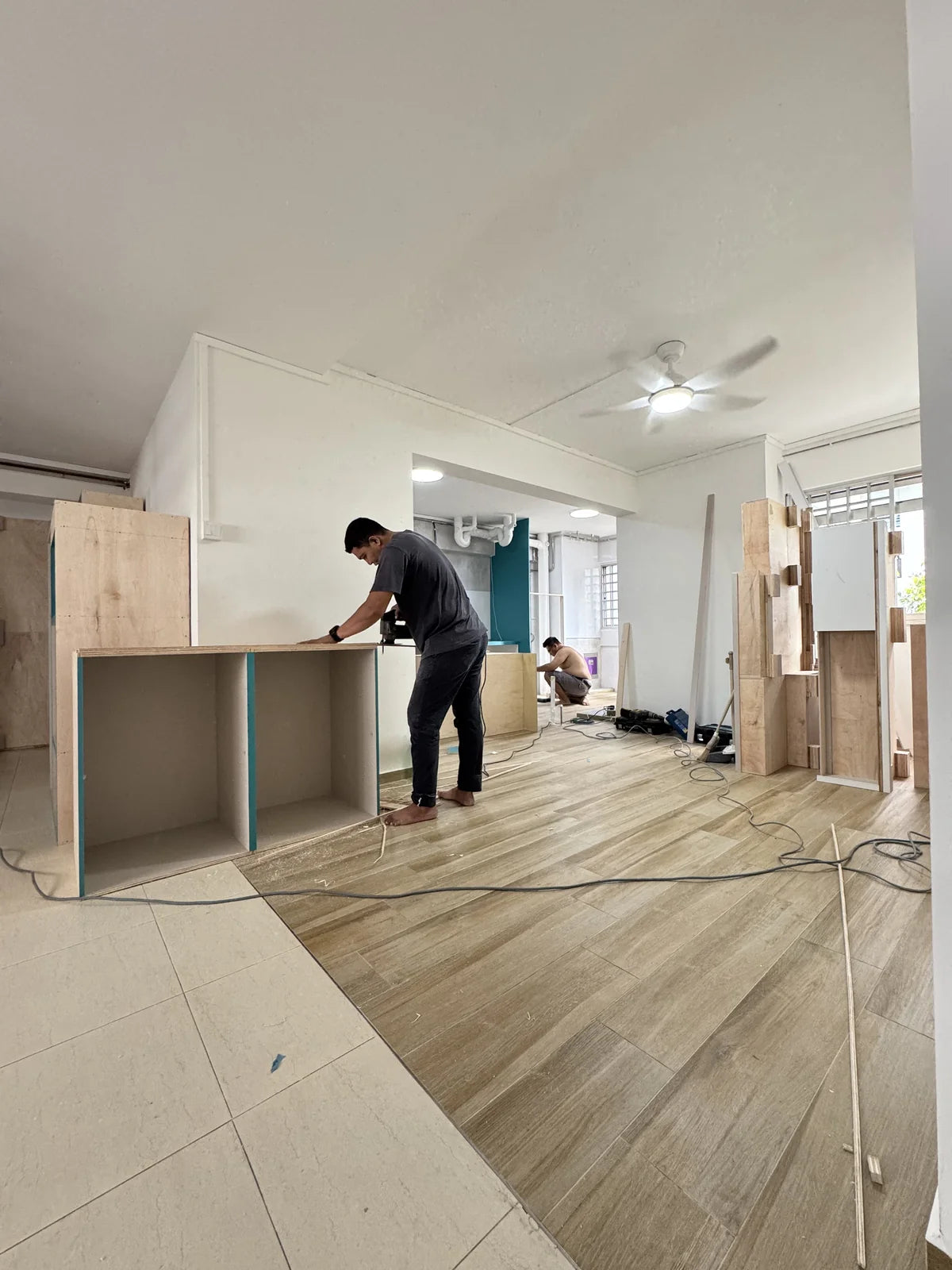 Carpenter fitting built-in cabinets on site