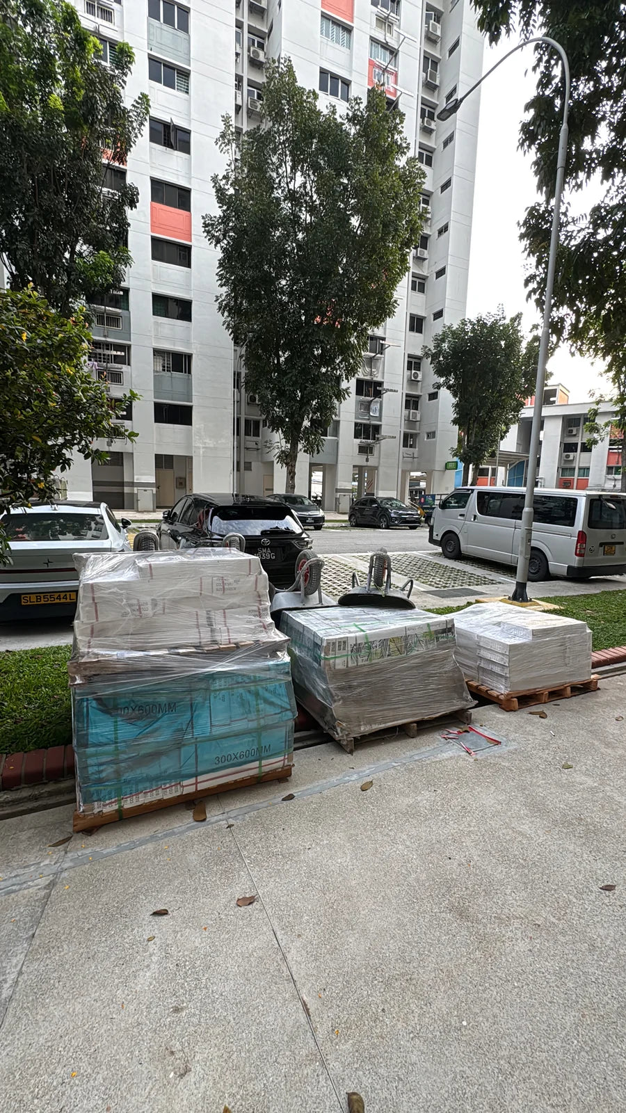 Tiles and renovation materials delivered to the foot of an HDB block